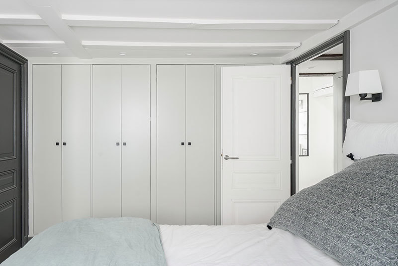 Белая мансардная квартира с голубым диваном в Париже Белая мансардная квартира с голубым диваном в Париже