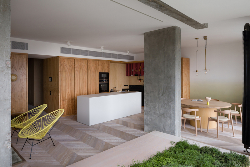 Комбинация дерева, бетонных поверхностей и минималистичной мебели в интерьере уютных апартаментов