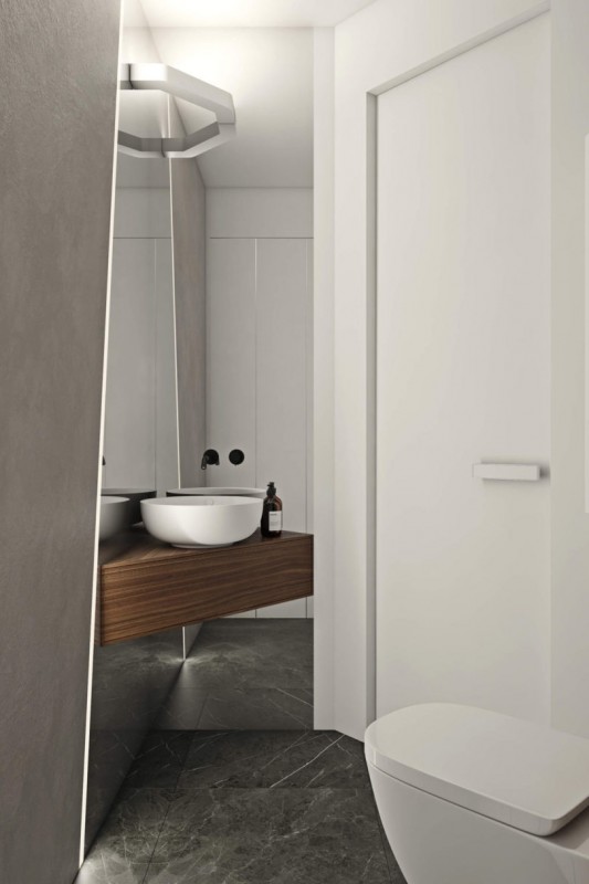 Использование черного, белого и цвета дерева в интерьере просторных минималистских апартаментов