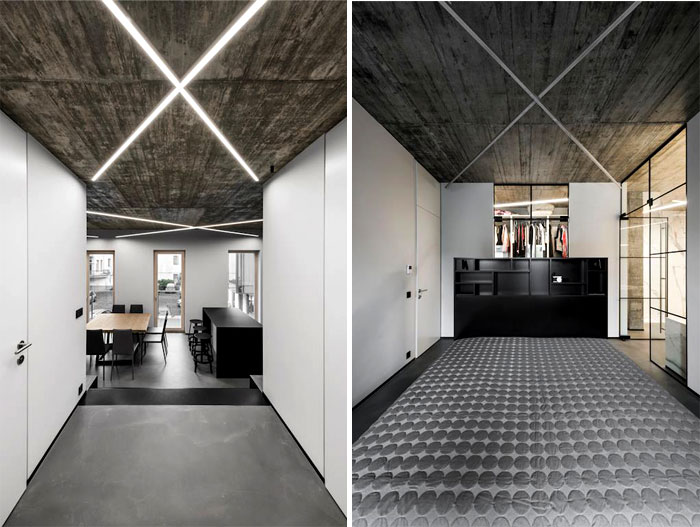 Открытые бетонные потолки с неоновым освещением и черные акценты в интерьере стильных апартаментов