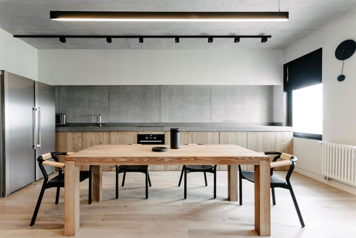 Бетон со светлым деревом, оттенки серого с черными элементами в интерьере квартиры площадью 75 м2